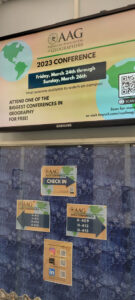 Directional sign welcomes attendees to various streamed sessions within the Humanities and Social Sciences building during the California State University, Fullerton AAG 2023 node events.