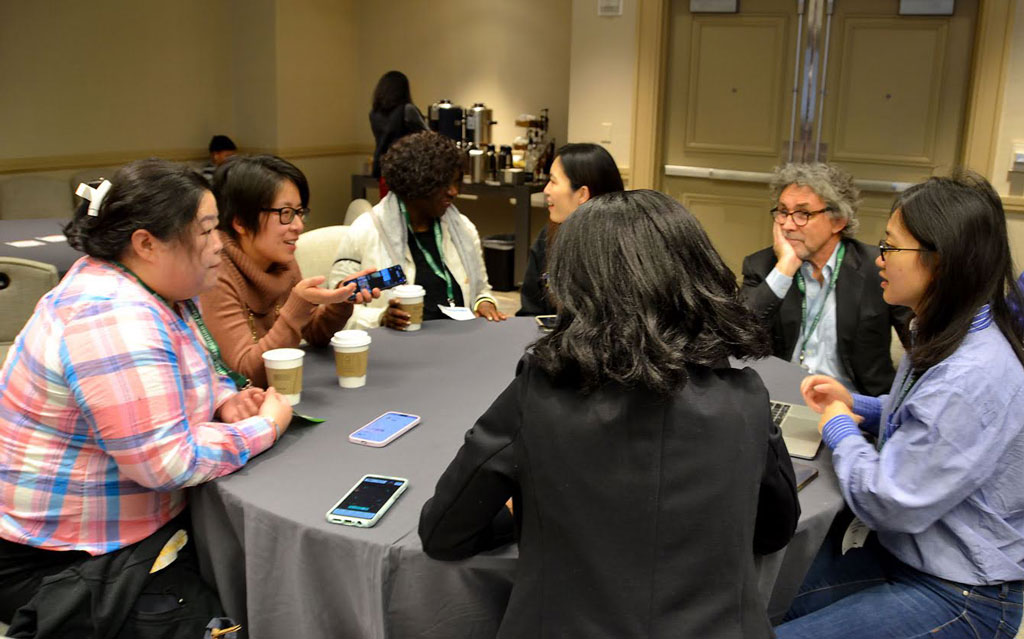 Attendees participate in a discussion during the "The Golden Compass Onward: Securing success of foreign-born women faculty in their career, leadership, and life in the United States" roundtable session during the AAG 2023 annual meeting.