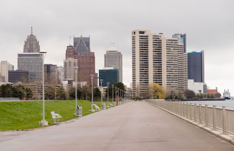 Waterfront walkway in downtown Detroit with city skyline in background