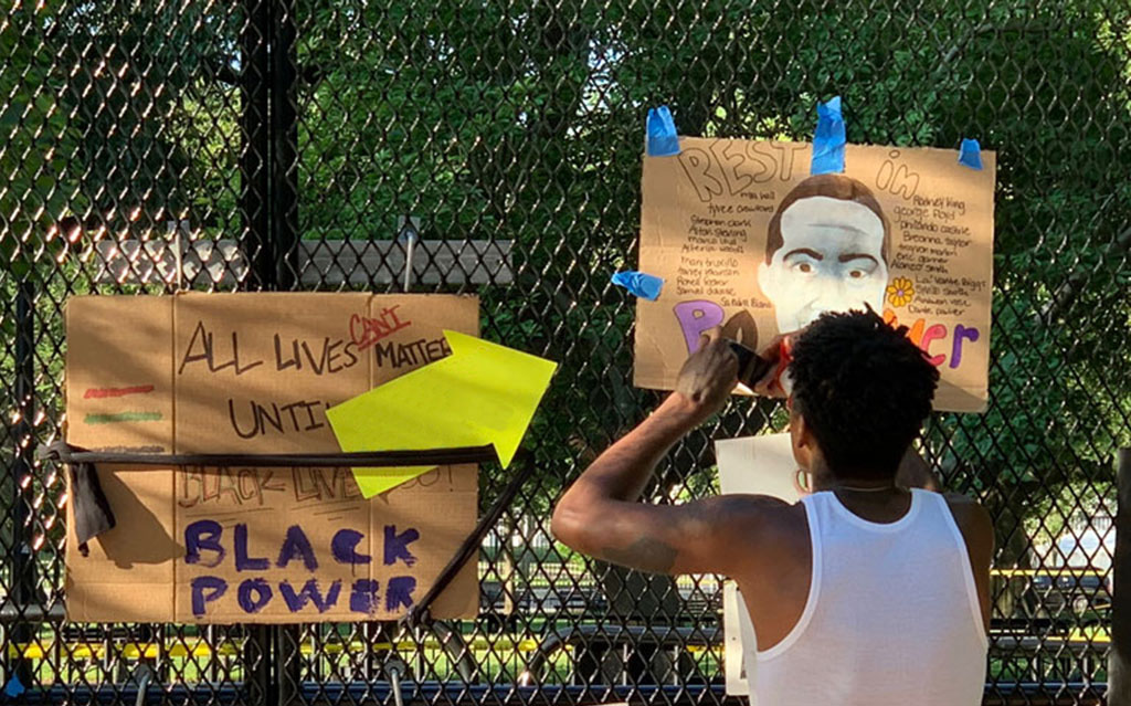 Image showing signs placed on fencing outside Lafayette Park in Washington, DC, on June 7, 2020; photo by Becky Pendergast