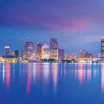 Detroit skyline at sunset showing blue and pink sky