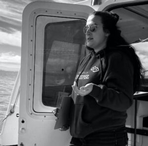 Julia Rose Dowell standing in a ship bulkhead during her work with San Francisco Baykeeper as a field investigator