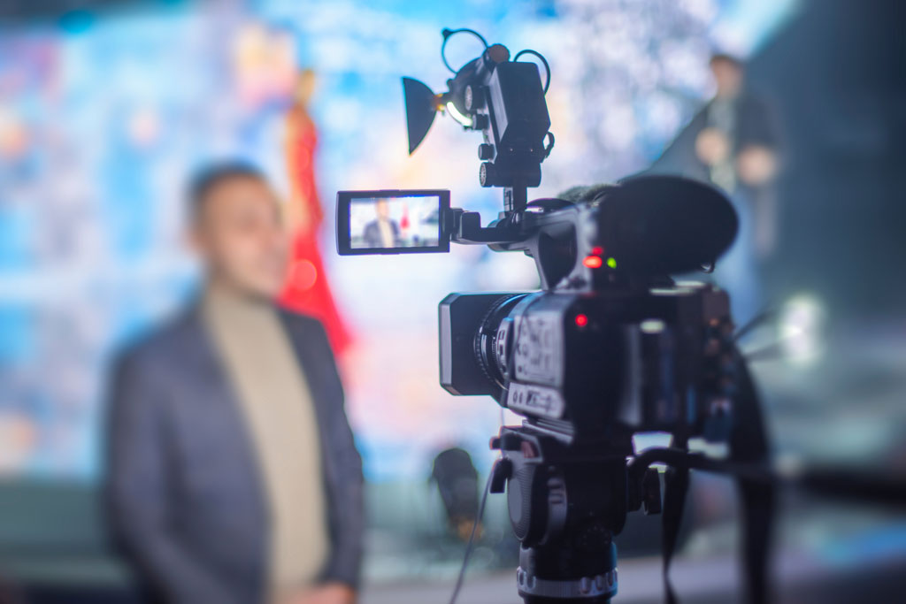 Video camera filming an interview with a person